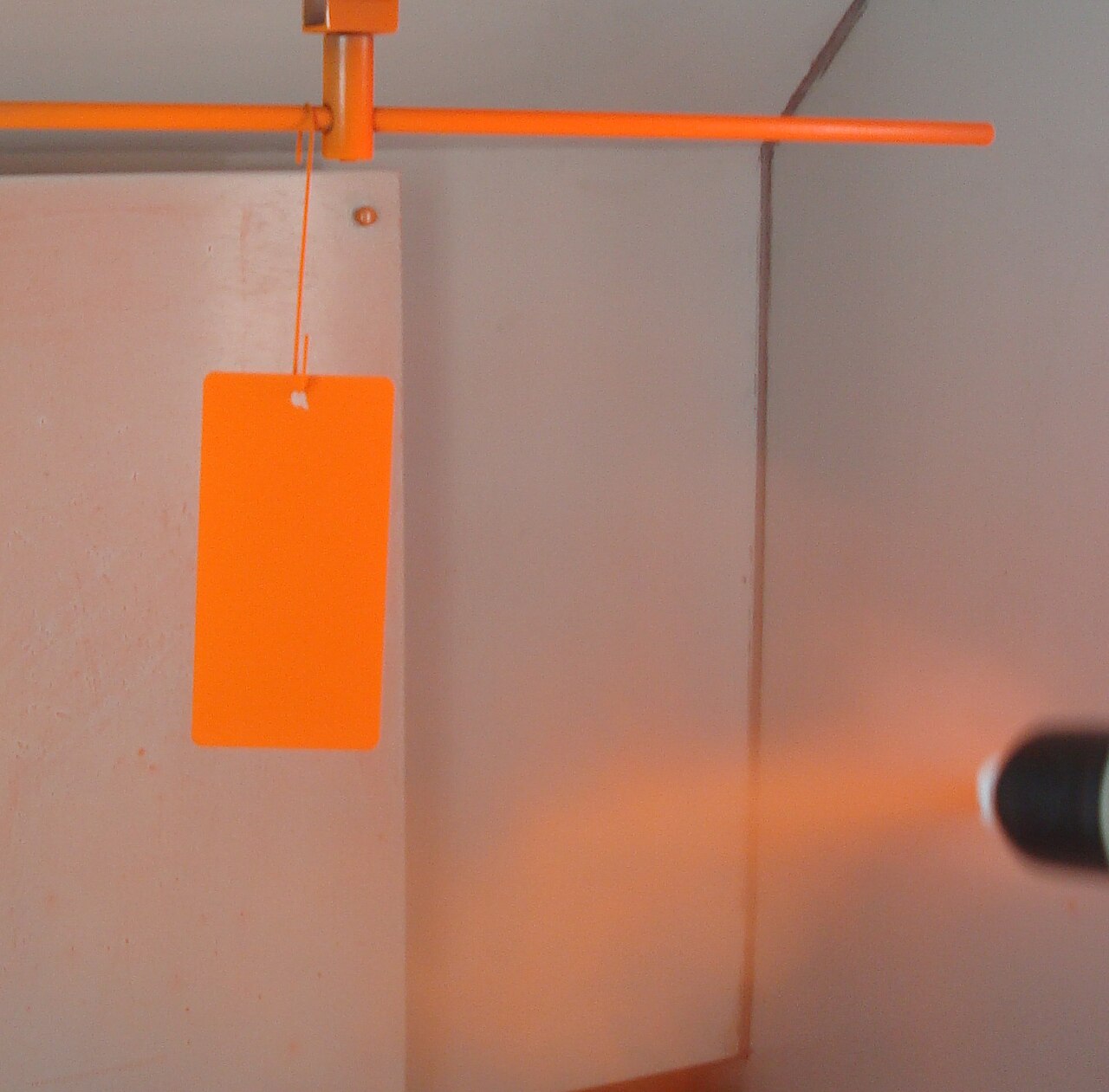 Powder coating applied to a hanging metal panel, illustrating the coating and colour category