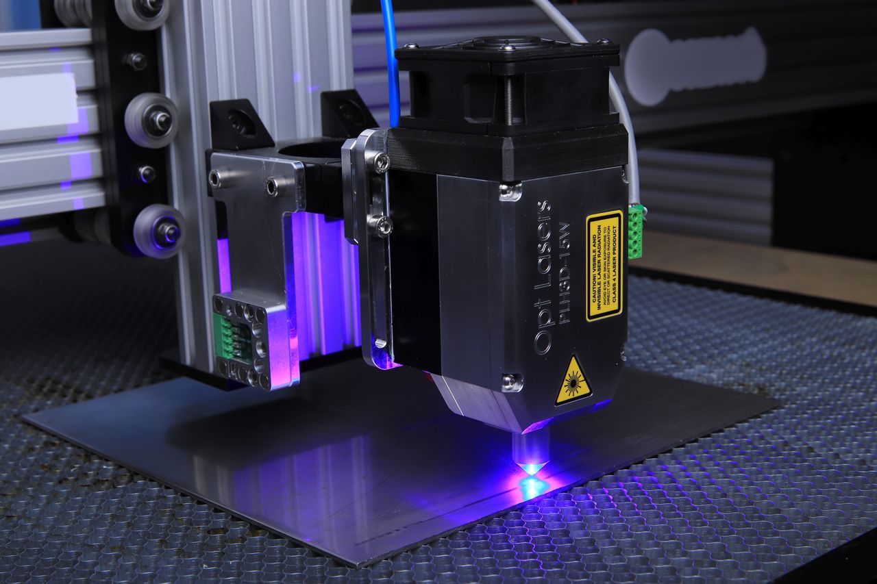 Close-up of a laser engraving machine working on a surface, illustrating the graphics and marking category
