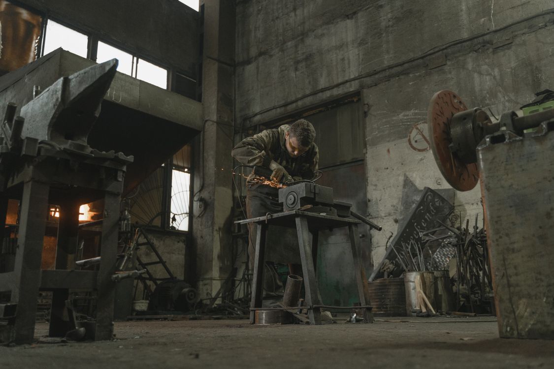 An angle grinder smoothing a metal surface, illustrating the smoothing and texture category